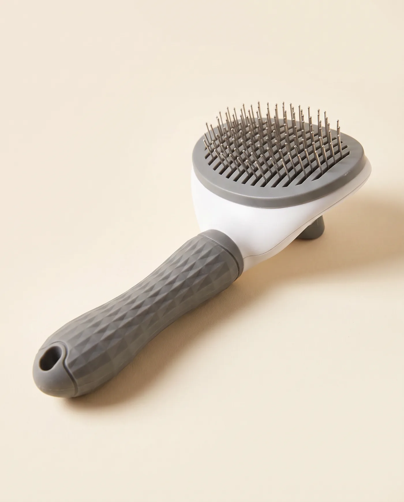 Brosse slicker autonettoyante